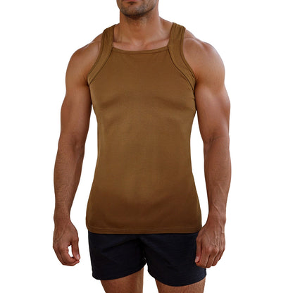 Man wearing a brown tank top and black shorts on a white background