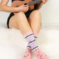 Women wearing music design novelty crew socks at home